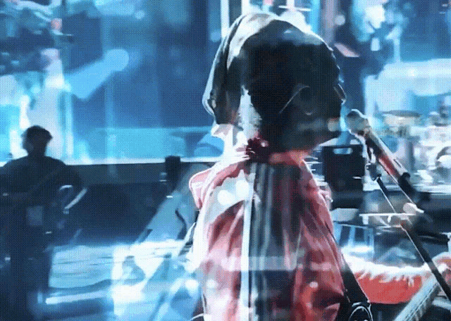 a blurry image of a person holding a microphone
