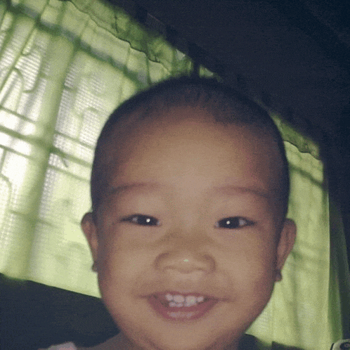 a close up of a child 's face with a green background