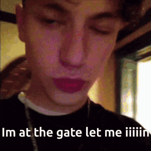 a close up of a person 's face with the words im at the gate let me iiiiin written below it