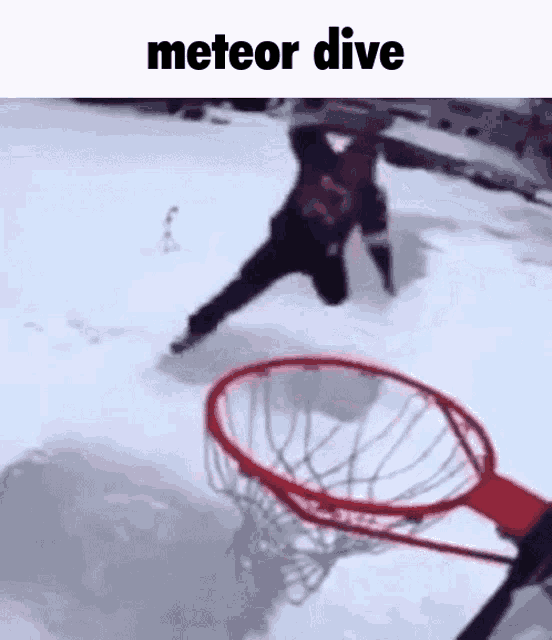 a man is jumping into a basketball hoop in the snow with the words meteor dive above him .