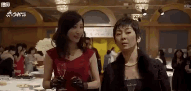 two women are standing next to each other in a room .