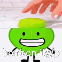 a person is touching a green cartoon character with the words bonbon illy / p written below it .