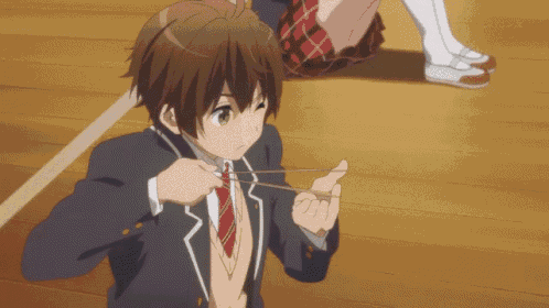 a boy in a school uniform is tying a tie