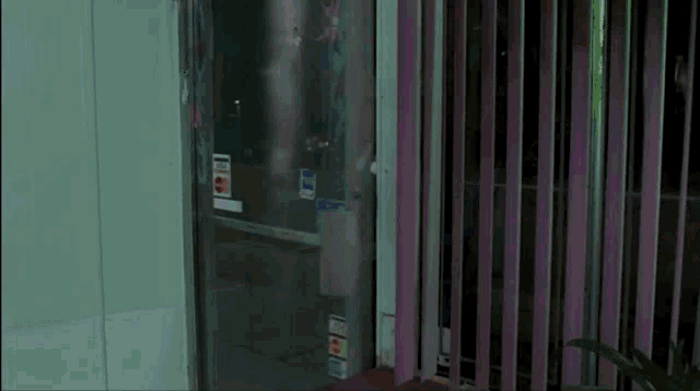a man walking in front of a pink wall