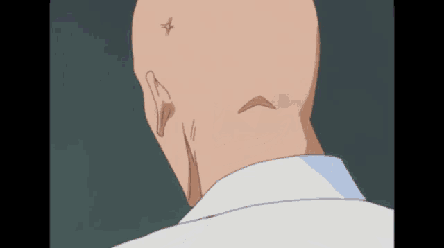 the back of a bald man 's head with a star on his forehead