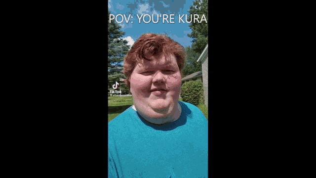 a man with red hair is wearing a blue shirt and says " pov you 're kura " .