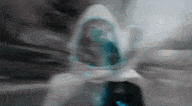a blurry picture of a person in a white hood