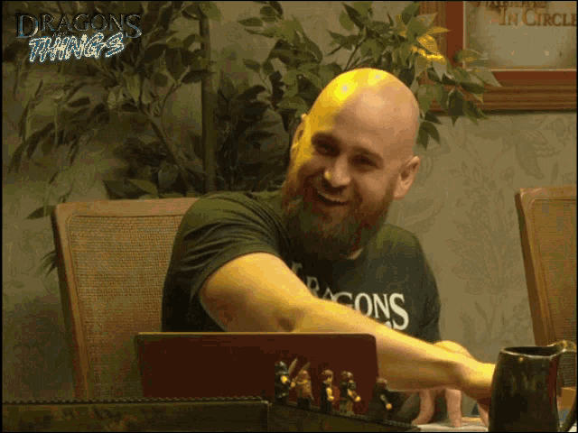 a man with a beard wearing a dragons things shirt