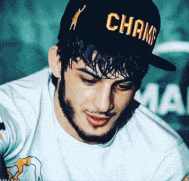 a man wearing a black hat with the word champ on it