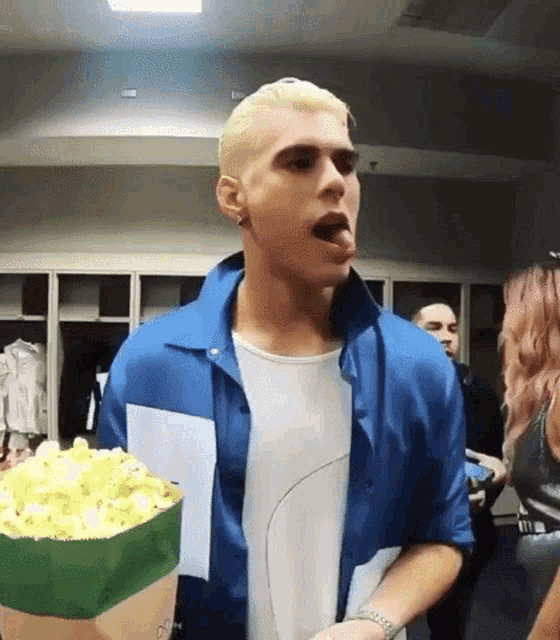 a man is holding a bag of popcorn in a locker room .