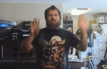 a man with a beard is wearing a black t-shirt with a picture of a monkey on it