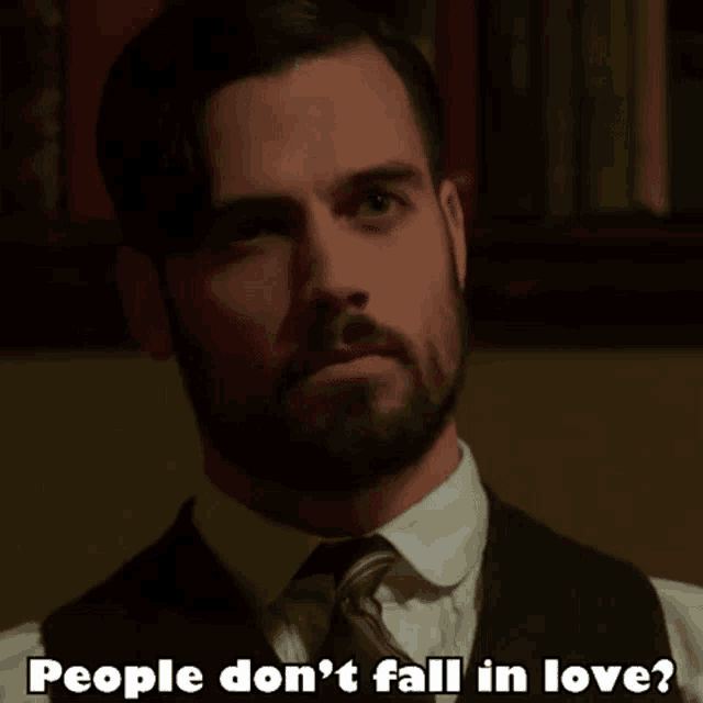 a man in a suit and tie says people don t fall in love