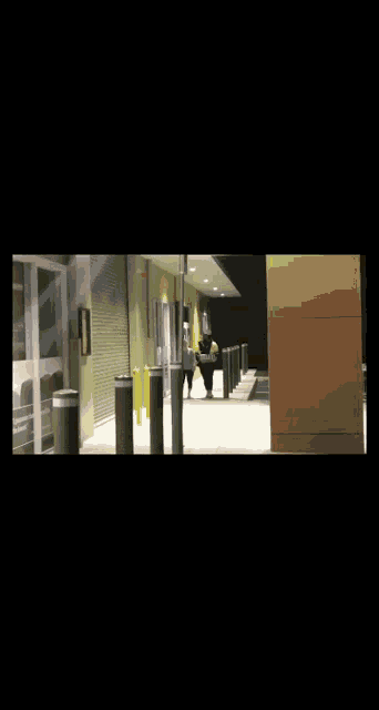 a man in a white robe walks down a street