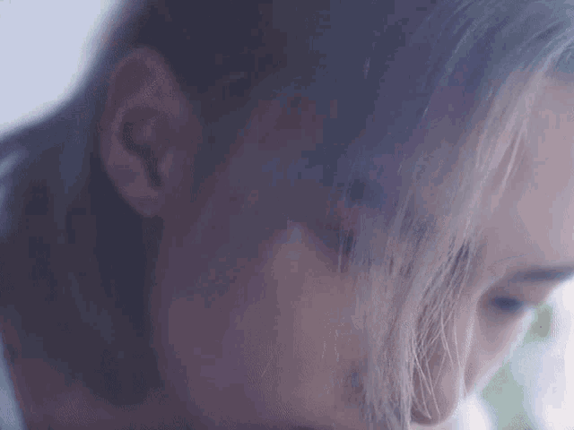 a close up of a woman 's face with long hair