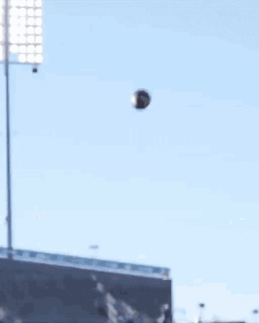 a football player jumps in the air to catch a pass