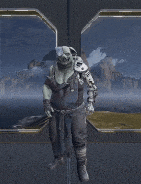 a man with a robotic head is standing in front of a window with mountains in the background