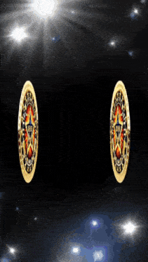 a pair of gold oval shaped earrings with a star design