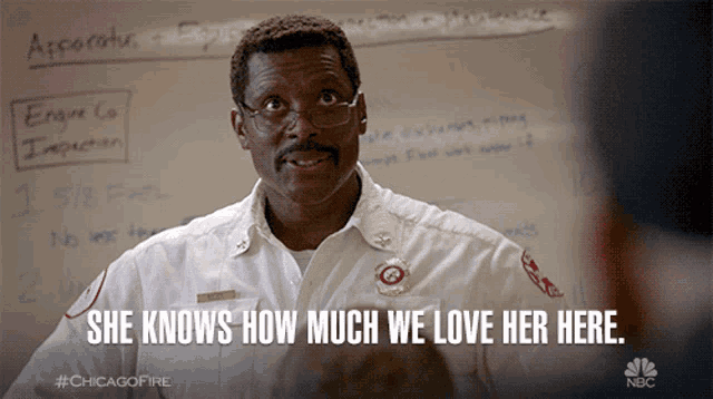 a man says she knows how much we love her here in front of a white board