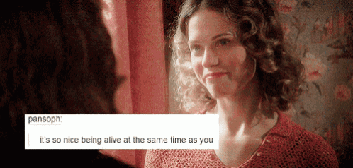 a woman in a red shirt is looking at another woman in a red shirt .