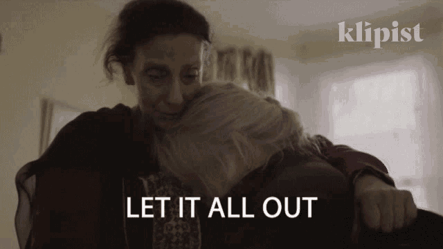 a woman hugging another woman with the words let it all out above them