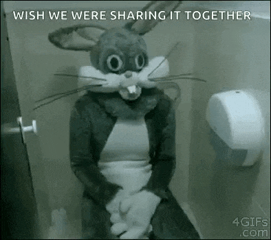 a person dressed as a bunny rabbit is sitting on a toilet .