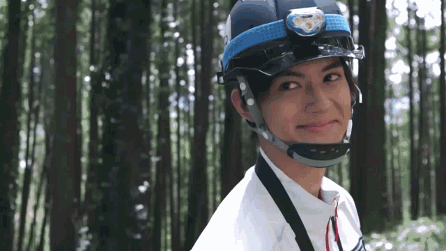a man wearing a helmet with a headlamp on his head