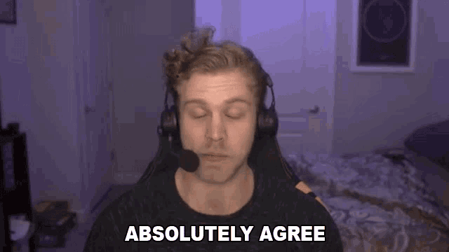 a man with headphones and a microphone says absolutely agree