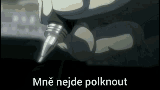 a close up of a person holding a pen with the words mne nejde polknout written on the bottom