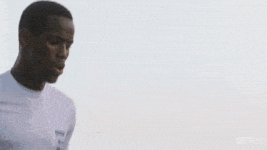 a man in a white shirt with the number 7 on it is running