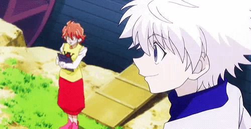 a boy and a girl are standing next to each other in a field and looking at each other .