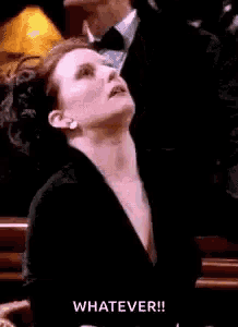 a woman in a black dress is looking up with the word whatever written below her