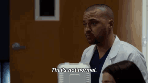 a man in a lab coat is standing next to a woman and saying `` that 's not normal '' .