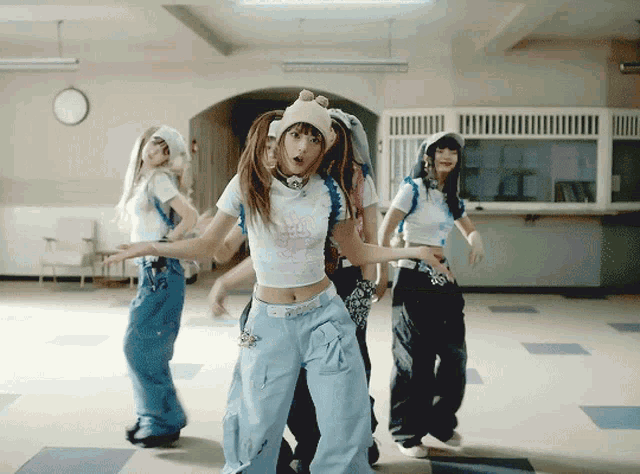 a group of girls are dancing in a hallway