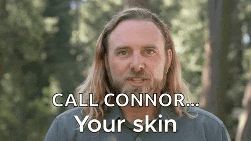 a man with long hair and a beard is saying " call connor your skin "
