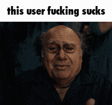 a man is giving a thumbs up with the words this user fucking sucks above him