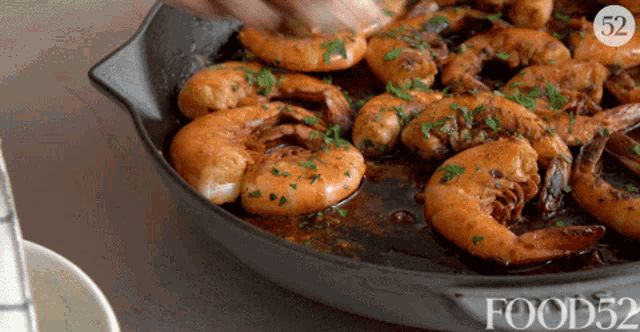 a frying pan filled with shrimp with the number 52 on the bottom