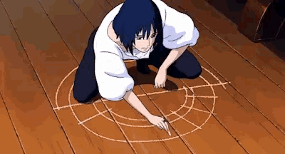 a person drawing a circle on the floor with chalk
