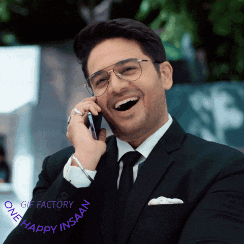 a man in a suit and tie is talking on a cell phone