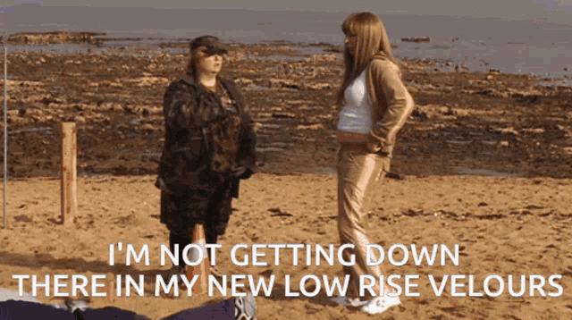 two women standing on a beach with the words " i 'm not getting down there in my new low rise velours "