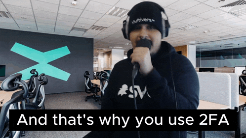 a man singing into a microphone with the words and that 's why you use 2fa