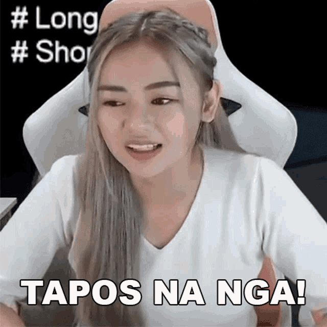 a woman sitting in a chair with the words " tapos na nga " written on her face