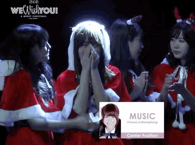 a group of girls in santa costumes are standing in front of a sign that says " music center position "