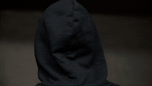 a close up of a man 's face with a hoodie on