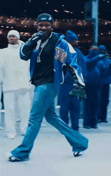 a man in a blue jacket with the letter b on the front