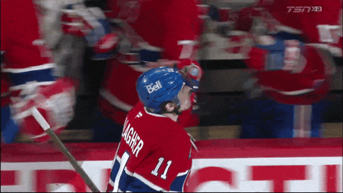 a hockey player wearing the number 11 jersey