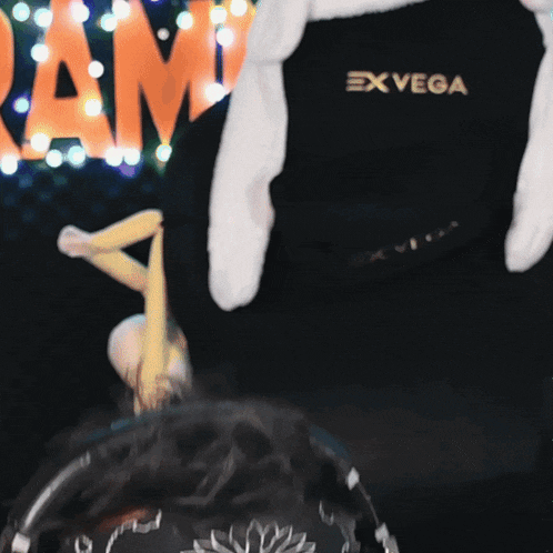 a person wearing a black shirt with the word exvega on it