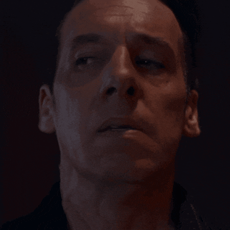 a close up of a man 's face with his eyes closed and his mouth open
