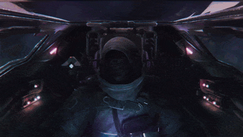 a video game character with a hood on is sitting in the cockpit of a vehicle