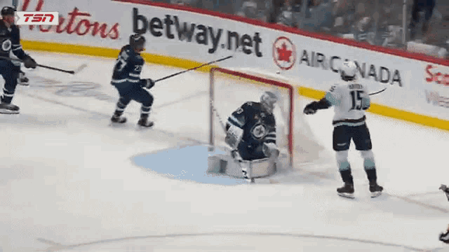 a hockey game is being played in front of an ad for betway