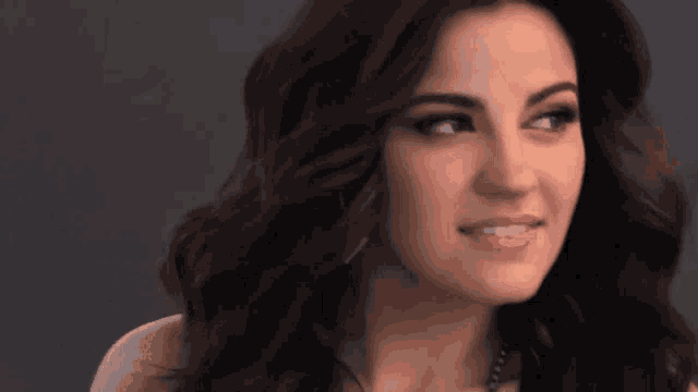 a close up of a woman 's face with dark hair